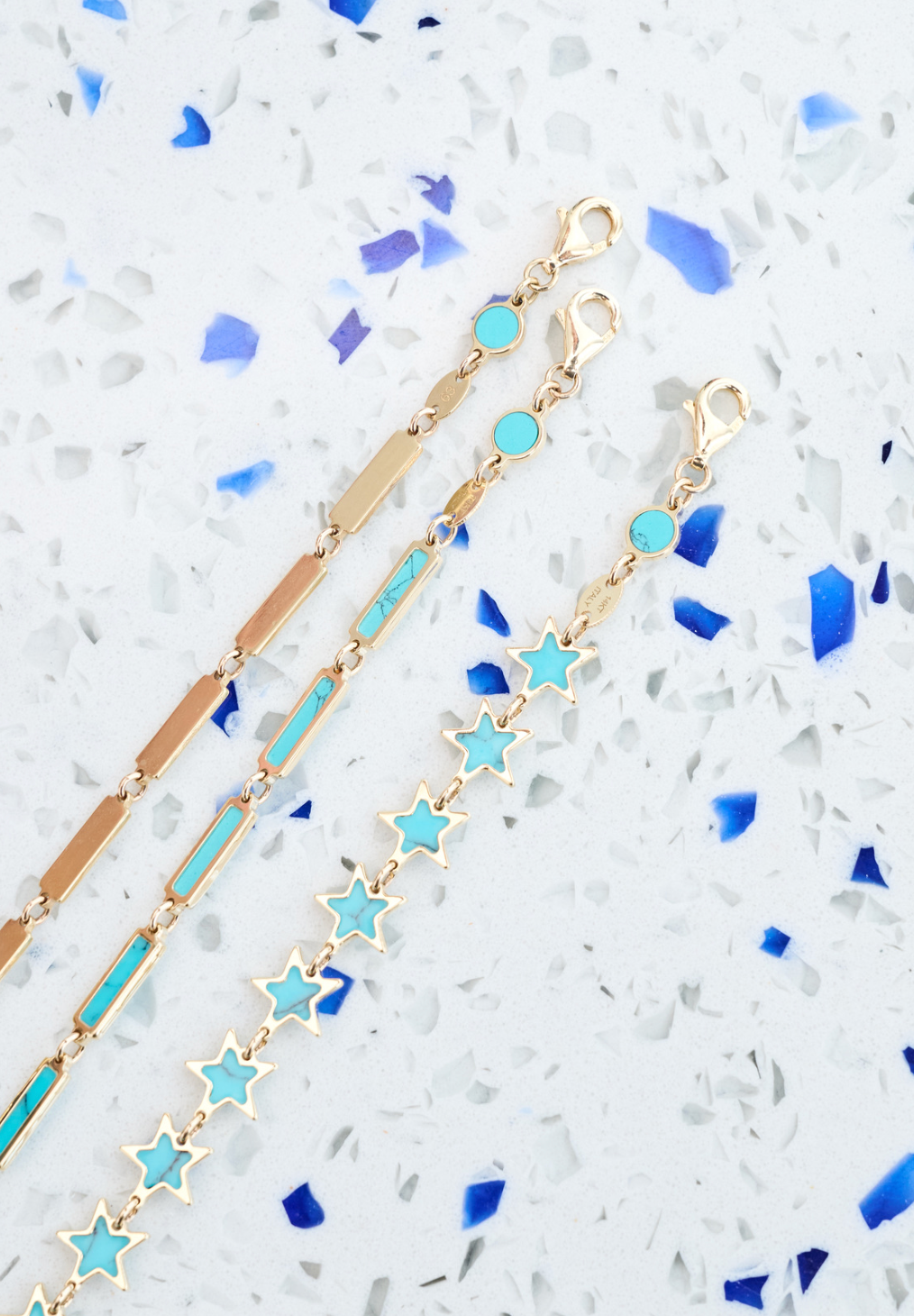 Blu Scarpa turquoise bracelets on blue terrazzo