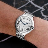 Front view of a Cartier Ballon Bleu W69012Z4 watch featuring a polished stainless steel case, 42mm size, and a classic blue cabochon crown.