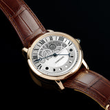 Front view of a Cartier Rotonde Jour & Nuit W1556243 watch featuring a rose gold case, 43.5mm size, with a classic white dial and elegant hour markers.