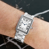 Front view of a Cartier Tank Solo W5200014 watch featuring a stainless steel case, measuring 34.8mm by 27.4mm, with a classic rectangular design and a white dial.