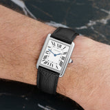 Front view of a Cartier Tank Solo WSTA0028 watch featuring a stainless steel case, measuring 34.8mm x 27.4mm, with a classic white dial and Roman numeral hour markers.Front view of a Cartier Tank Solo WSTA0028 watch featuring a stainless steel case, measuring 34.8mm x 27.4mm, with a classic white dial and Roman numeral hour markers.