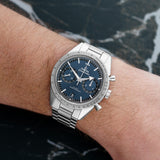 Front view of an Omega Speedmaster 57 watch featuring a stainless steel case, 40.5mm size, and a classic chronograph design with a black dial and silver-tone hands.