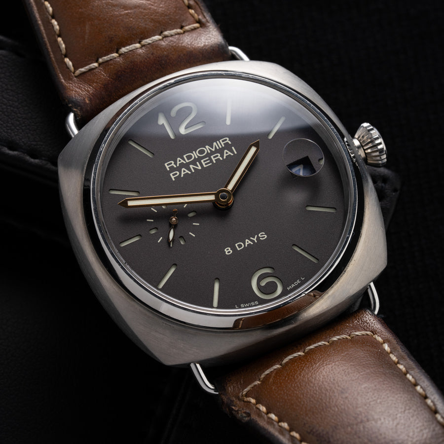 A Panerai Radiomir 8 Days watch with a black dial, titanium case, and a brown leather bracelet.
