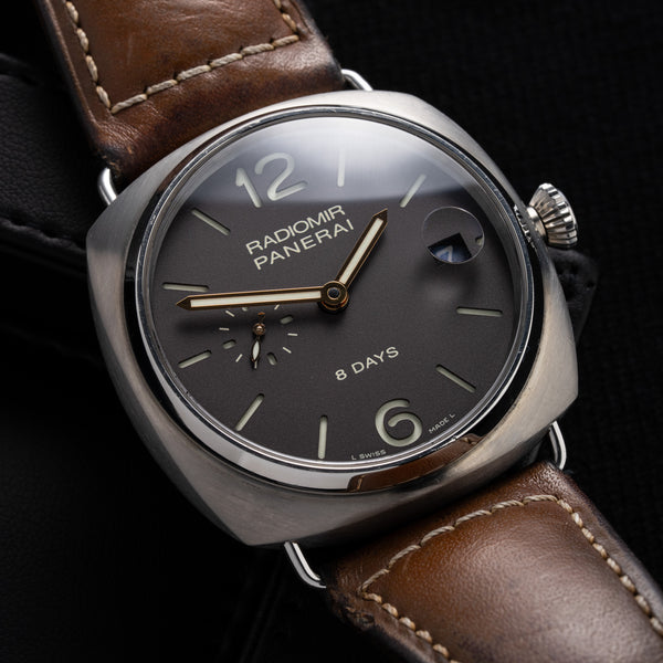 A Panerai Radiomir 8 Days watch with a black dial, titanium case, and a brown leather bracelet.