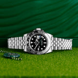Front view of a Rolex GMT Master II "Bruce Wayne" 126710GRNR, featuring a stainless steel case and a 40mm size, with a black and green bezel and a black dial.
