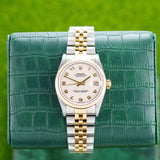 Front view of a Rolex Datejust 68273 watch featuring a stainless steel and yellow gold case, 31mm size, with a classic design and elegant dial.