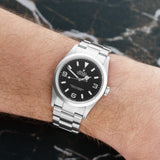 Front view of a Rolex Explorer 114270, featuring a 36mm stainless steel case, black dial, white hour markers, and silver hands.