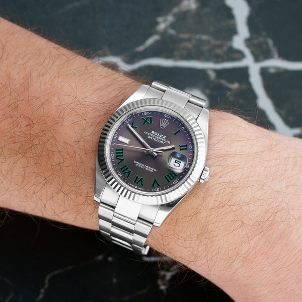 Front view of a Rolex Datejust 126334 featuring a stainless steel case and 41mm size, showcasing a purple silver dial with luminous hour markers and a date function.