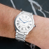 Front view of a Cartier Ronde Must WSRN0035 watch, featuring a polished stainless steel case and a 40mm diameter, showcasing its elegant design and classic dial.