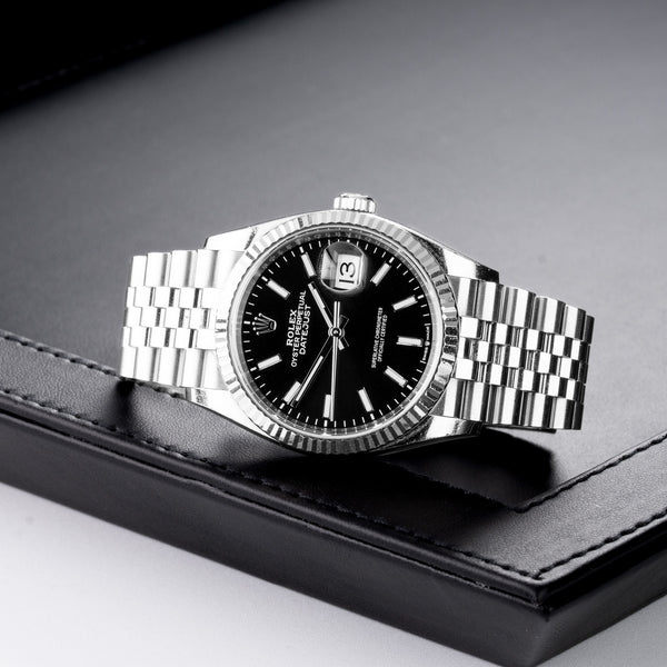 Front view of a Rolex Datejust 126234 watch, featuring a stainless steel case and a 36mm size, showcasing a classic design with a silver dial and diamond hour markers.