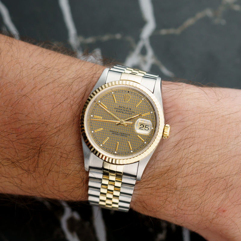 Front view of a Rolex Datejust 16233 featuring a stainless steel and yellow gold case, 36mm size, with a classic silver dial and gold hour markers.