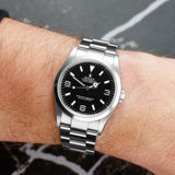 Front view of a Rolex Explorer 114270 featuring a stainless steel case and a 36mm diameter, showcasing its sleek design and classic black dial with white hour markers.