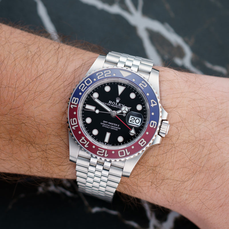 Front view of a Rolex GMT Master II 126710BLRO, featuring a 40mm stainless steel case, black and blue ceramic bezel, and a black dial with luminous hour markers and hands.