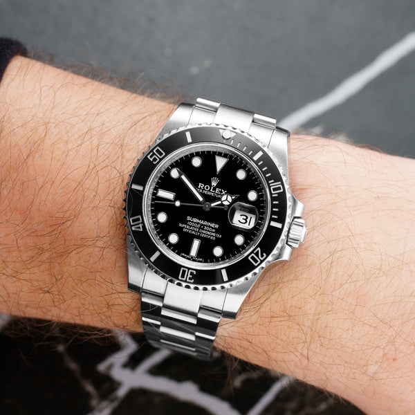 Front view of a Rolex Submariner Date 116610LN featuring a stainless steel case, 40mm size, black dial, and ceramic bezel.