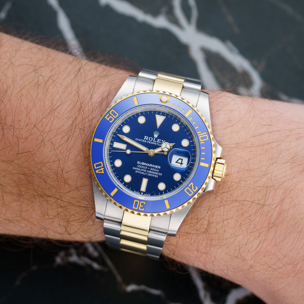 Front view of a Rolex Submariner Date 126613LB featuring a stainless steel and yellow gold case, 41mm size, with a blue dial and gold hour markers.